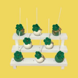 Cake pops decorados con flores verdes y detalles dorados. Perfectos para eventos elegantes en el Bronx, NY.